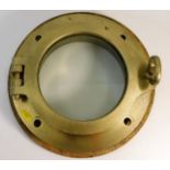 A brass ships porthole with back plate by Swinburn