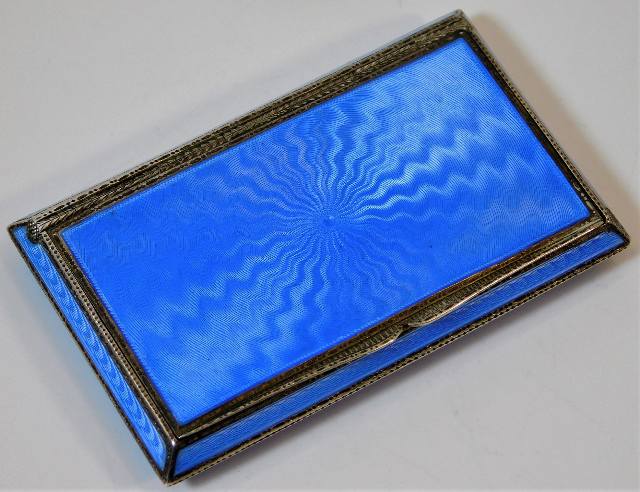 An enamelled silver cigarette case with gilt inter