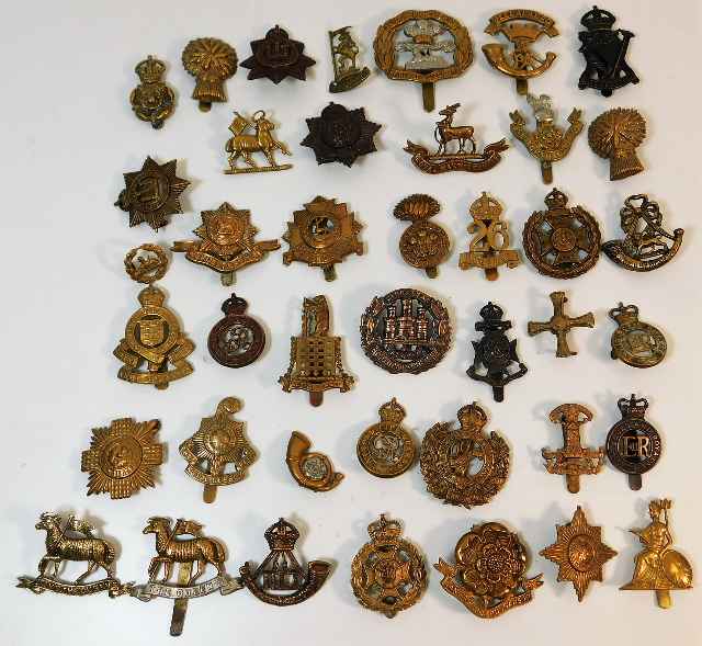 Approx. 41 military helmet & cap badges