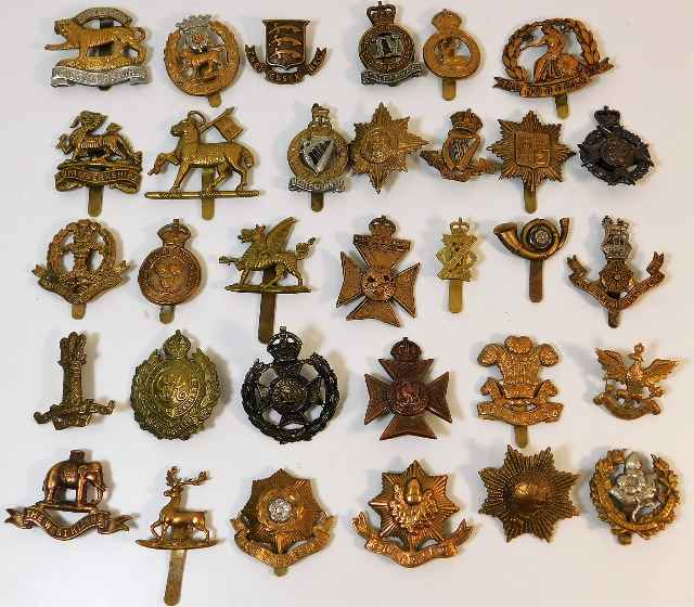 Approx. 32 military helmet & cap badges