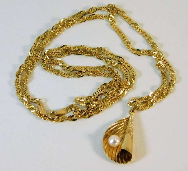 A 9ct gold chain with folded leaf & pearl pendant