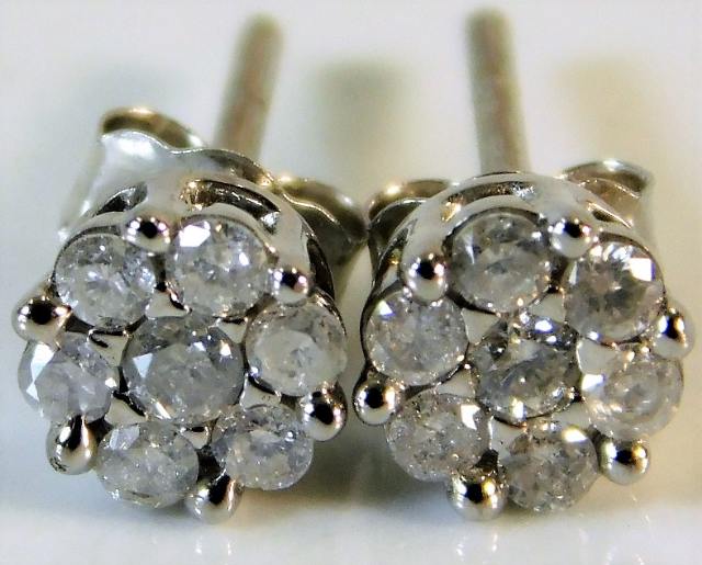 A pair of 9ct white gold earrings set with approx.