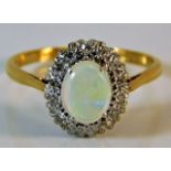 An 18ct gold ring set with opal & diamond 3.2g siz