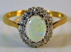 An 18ct gold ring set with opal & diamond 3.2g siz