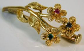 A 15ct gold floral brooch set with emerald, sapphi