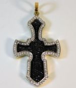 An 18ct two colour gold cross set with approx. 3ct