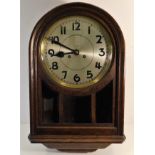 A 1920's oak wall clock with silvered dial 24in hi