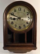 A 1920's oak wall clock with silvered dial 24in hi