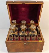 A gilded six bottle Regency period decanter set wi