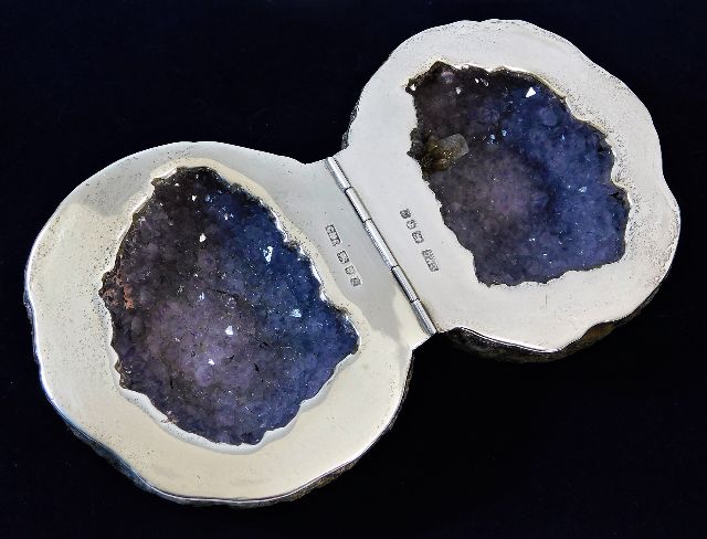 A hallmarked silver mounted split amethyst geode.