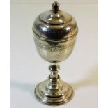 A white metal lidded goblet with chased decor appr