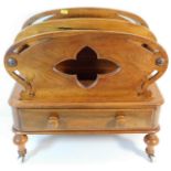 A Victorian walnut Canterbury with drawer under on