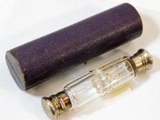 A cased double ended faceted glass scent bottle
