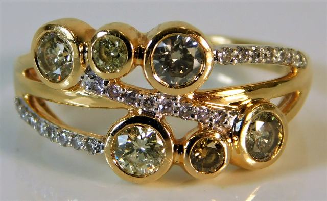 An 18ct gold ring set with three colour fancy diam