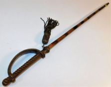 An antique child's walking cane in the form of a s