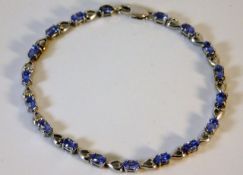 A 9ct white gold bracelet set with tanzanite 7.75i