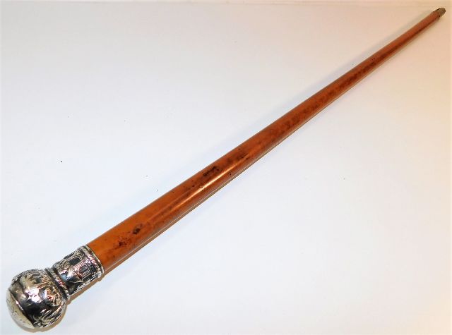 A malacca walking cane with decorative white metal