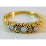 An 18ct gold ring set with opal & diamonds within