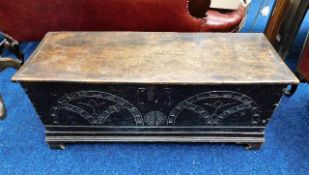 A 17th/18thC. oak coffer with carved decor to fron