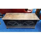 A 17th/18thC. oak coffer with carved decor to fron