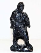 An antique Chinese carved black jade figure, chip