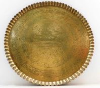 An antique brass Persian tray with scalloped edge decorated with trees & script, dated 1299 19.875in