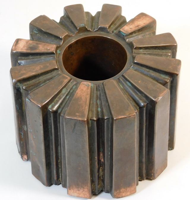 An antique copper jelly mould of segmented design