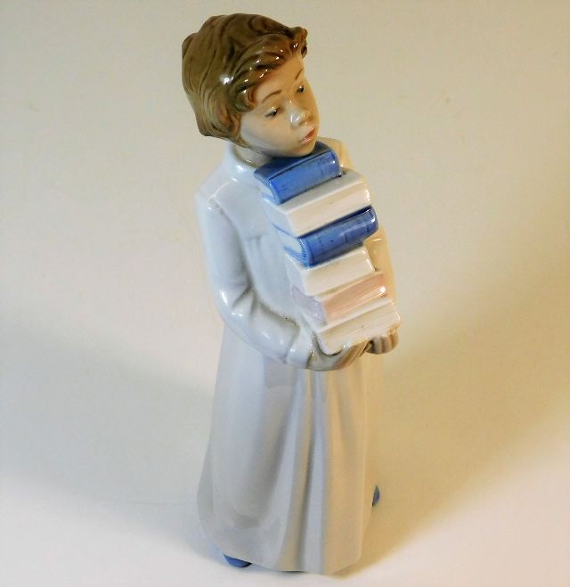 A large Lladro Nao porcelain figure of child carry