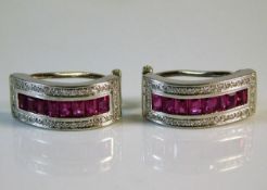 A pair of 18ct gold earrings set with ruby & diamo