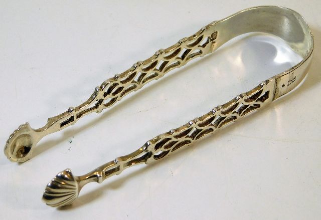 A pair of Georgian silver sugar tongs with lattice