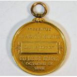 A yellow metal medallion, tests as 18ct gold, "The