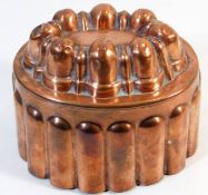 An antique copper jelly mould 3.625in tall