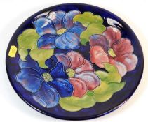A signed Moorcroft pottery plate 10.25in wide