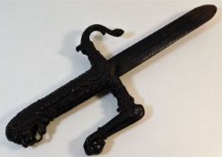An antique cast iron sword with lion pommel, blade