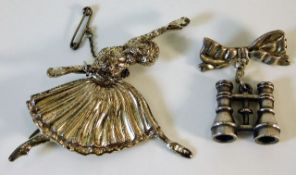 A silver dancer brooch twinned with a silver bow &