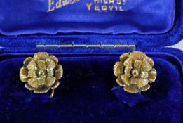 A pair of 9ct gold floral earrings with carved dec
