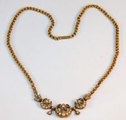 An antique yellow metal necklace set with pearl 12