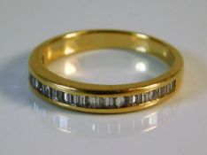 A yellow metal half eternity ring, tests as 18ct g