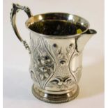 A Victorian silver cream jug with embossed decor G