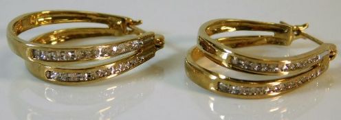 A pair of 9ct gold double hooped diamond set earri