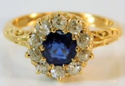 An antique 18ct gold sapphire ring with carved shoulder decor set with approx. 0.6ct old cut diamond