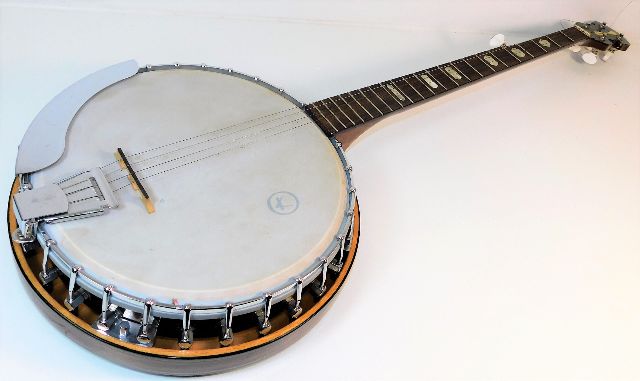 A vintage banjo, some losses to strings