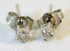 A pair of 9ct white gold diamond earrings 0.7g