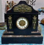 A large, heavy slate mantle clock with applied gil