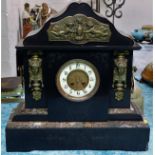 A large, heavy slate mantle clock with applied gil