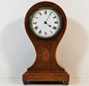 A French Edwardian oak cased balloon clock with in