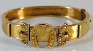 An antique yellow metal bangle with seed pearl dec