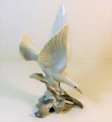 A Lladro porcelain bird in flight figure 11.25in h