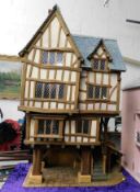 A large Tudor style dolls house 49.25in high x 28.