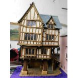 A large Tudor style dolls house 49.25in high x 28.